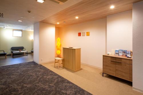 an office lobby with a desk and a chair at Yawarano-yu MARUYA For women only in Ise
