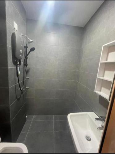 uma casa de banho com um chuveiro, um lavatório e um WC. em Neu Suites @3rdNvenue Ampang em Kuala Lumpur