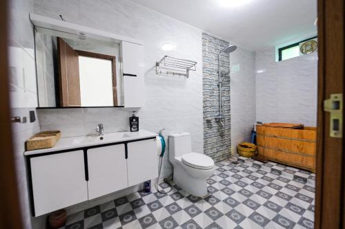 a white bathroom with a toilet and a sink at Dream Hill Villa - Biệt thự trên đồi full tiện ích dịch vụ, ăn uống, tổ chức event in Hanoi