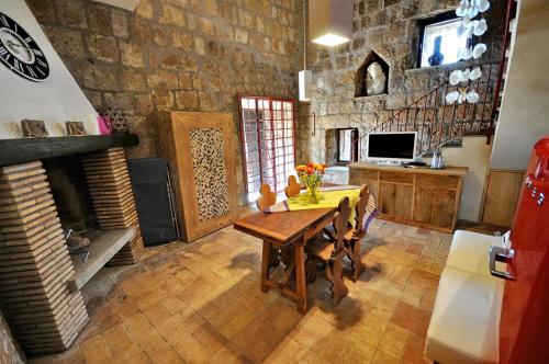 a dining room with a table and a fireplace at Country House La Torre in Tuscania