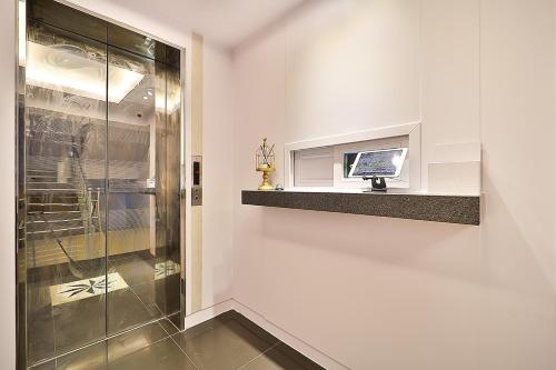 a bathroom with a television on a wall at Gwanganri A Hotel in Busan