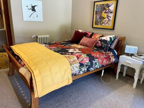 a bedroom with a bed with a colorful comforter at Studio 585 in Alexandra