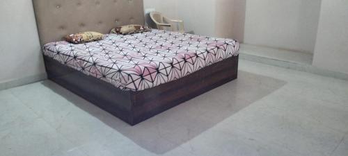 a small bed in a room with at Agarwal Guest House in Naya Raipur