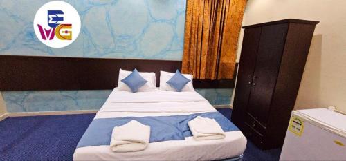 Llit o llits en una habitació de EWG Mahbas Hotel