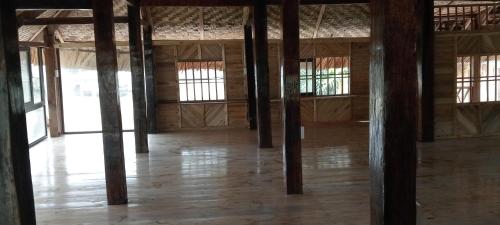 an empty room with wooden poles in a building at La Bằng Homestay in Lá Cam