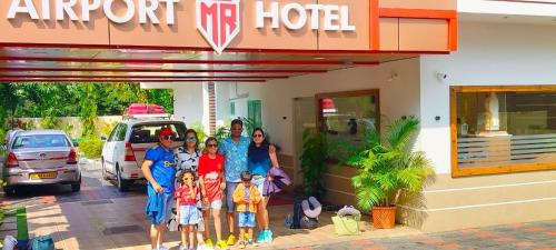 a group of people standing in front of a hotel at MARINA SUITES AIRPORT HOTEL in Cochin