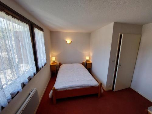 a bedroom with a bed and a large window at Appartement Autrans, 3 pièces, 6 personnes - FR-1-737-64 in Autrans