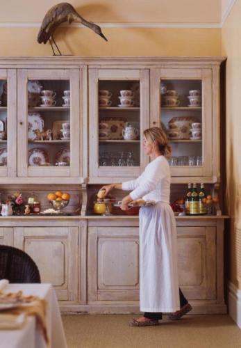 a woman standing in a kitchen preparing food at Tallman Hotel in Upper Lake