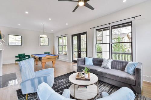 a living room with a couch and a pool table at Modern rooftop home in Midtown in Atlanta
