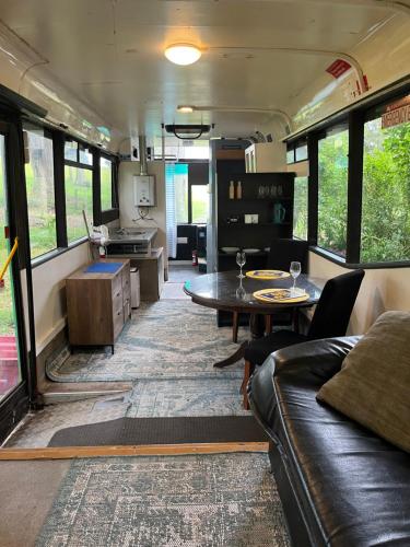 a living room with a couch and a table at Bush Bus 