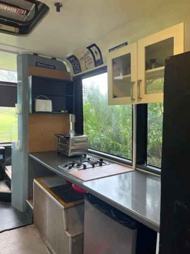 a kitchen in an rv with a counter top at Bush Bus 