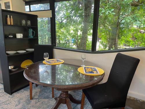 a dining room with a glass table and two chairs at Bush Bus 