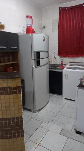a kitchen with a white refrigerator and a stove at Apartamento 1 Quarto No Centro para até 2 pessoas in Salvador