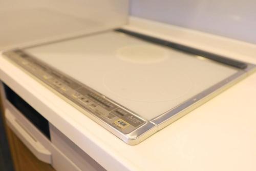 a laptop is sitting on top of a refrigerator at MolinHotels302アクティビティを満喫できる札幌定山渓 天然温泉付ホテル-1L1Room Q-Bed2&S-2 4persons in Jozankei