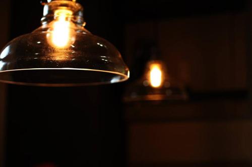 a glass jar with a lit candle in the background at MolinHotels302アクティビティを満喫できる札幌定山渓 天然温泉付ホテル-1L1Room Q-Bed2&S-2 4persons in Jozankei