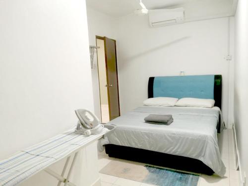 a white room with a bed and a mirror at Putatan Platinum Apartment with Pool in Kota Kinabalu