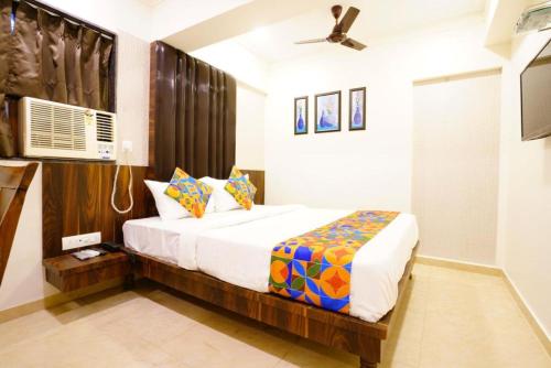 a bedroom with a bed in a room at Hotel Diamora Residency in Thane