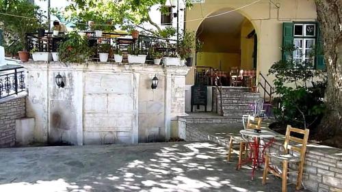 a patio with a table and chairs and a building at Elina's house in Koumeika