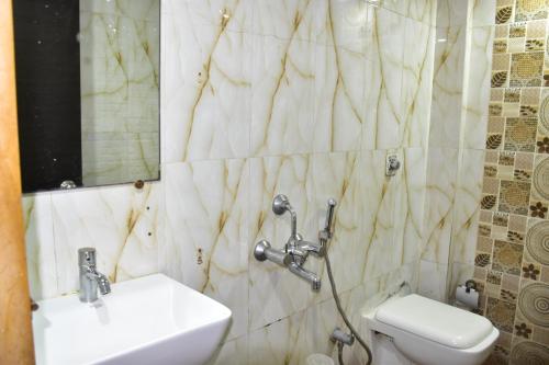 a bathroom with a sink and a toilet at Hotel BKC Palace Inn - Near US Consulate, Bandra Kurla Complex హోటల్ బి కే సి ప్యాలెస్ ఇన్ in Mumbai