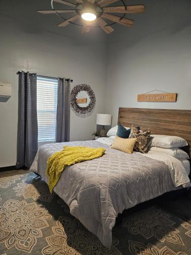 a bedroom with a large bed and a ceiling fan at Canadian river villas in Amarillo