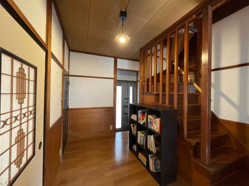 a hallway with a book shelf with books at Geoparadise Nishiizu in Shizuoka