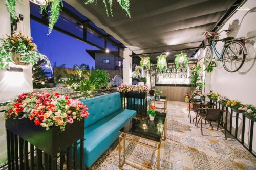 a patio with a blue couch and some flowers at Casa La Silvinas Hotel & Event Resort in Tagaytay