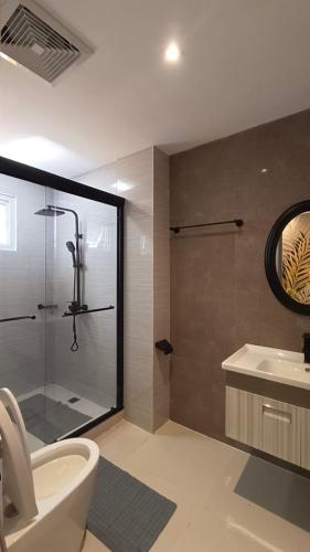 a bathroom with a shower and a toilet and a sink at Casa La Silvinas Hotel & Event Resort in Tagaytay