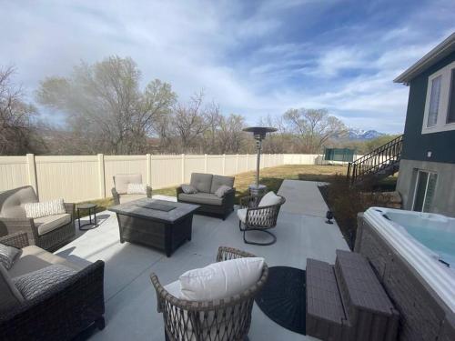 a patio with chairs and a table and a pool at Luxury 2 Bdrm 2 bath in heart of Salt Lake Valley in Murray