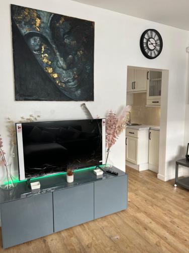 a living room with a large flat screen tv at Glendale Gardens Apartment in Southend-on-Sea