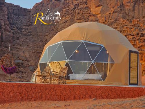 a dome tent with chairs in the desert at wadi rum,Rania camp in Wadi Rum