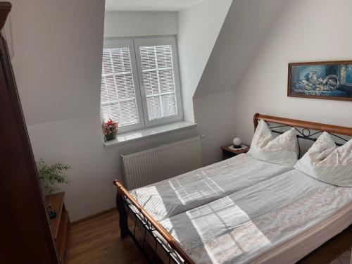 a bedroom with a bed and a window at Penzion Olga Hajasova in Bojnice