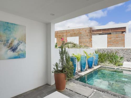 a villa with a swimming pool in a house at Résidence Celestial - Premium 3 bedrooms Villa with volcanic stone Pool in Grand Baie