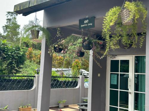 a porch with potted plants on the side of a house at 100 Oastel coLiving in Tanah Rata