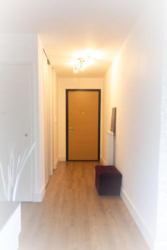a hallway with a brown door and a wooden floor at Bella Vista - New flat with View Confort & Calm near Geneva 5 PERS in Archamps