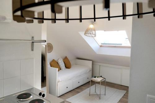 a living room with a white couch and a skylight at Nantes Central & Confort in Nantes