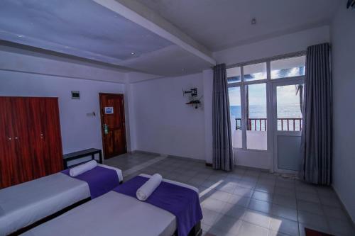 Postel nebo postele na pokoji v ubytování Hotel Wewala Beach