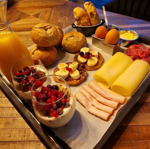 a tray of cheese and other foods on a table at Cottage Jacob in Zandvoort
