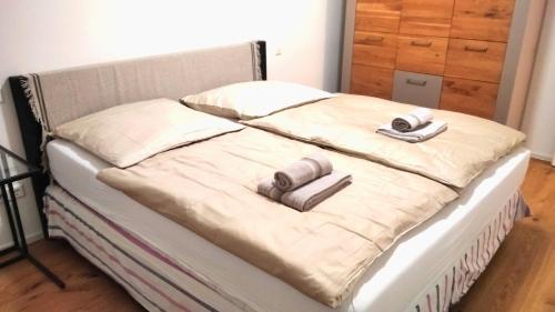 an unmade bed with two pillows on it at Sroom Metzingen in Metzingen