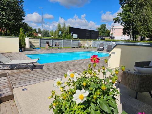 a backyard with a swimming pool and flowers at "Spring" apartment in Viljandi