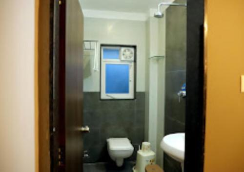 a bathroom with a toilet and a sink at LOTUS LODGE Kalmath in Kankauli