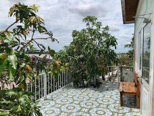 a balcony with trees and a bench on a house at ISLAND HOMESTAY TIỀN GIANG in Ấp Tân An Thi