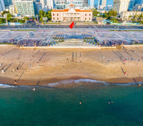 an aerial view of a beach with people in the water at GOLDEN PANORAMA LUXURY STUDIO in Nha Trang