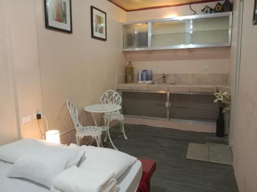 a bedroom with a bed and a table and a sink at TerisitaPlace - LoveAtFirst in Taytay