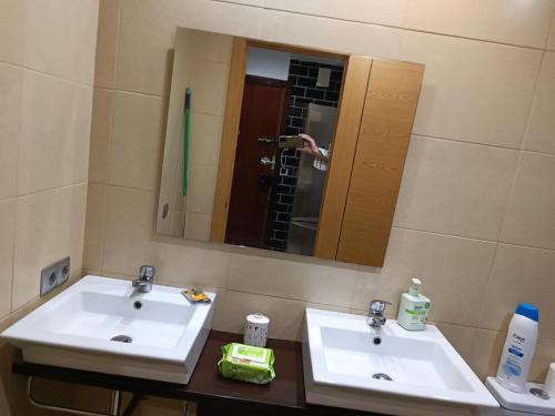 a bathroom with two sinks and a mirror at Alojamiento turístico MN in Seville