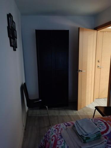 a bedroom with a bed and a black door at Alojamiento turístico MN in Seville