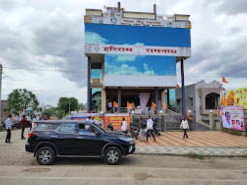 a black car parked in front of a building at Hotel Hariram Tower,Wardha in Wardha