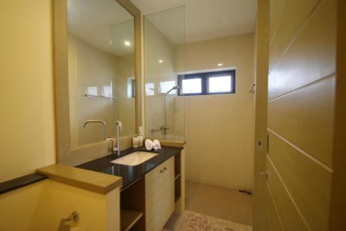 a bathroom with a sink and a mirror at Talay Sawan Pool Villa 27-12 in Bang Sare