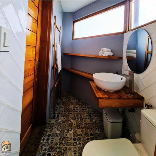 a bathroom with a sink and a mirror at Luna Tres Homestay Siargao in General Luna