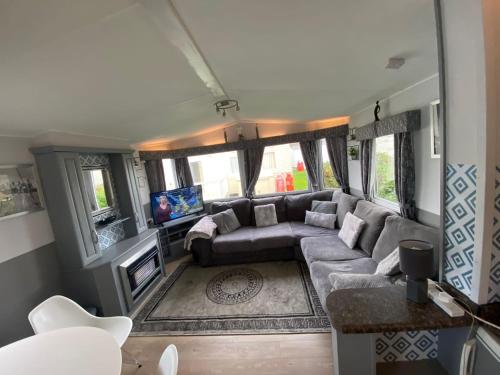 a living room with a couch and a tv at Haven caravan park Cala gran in Fleetwood