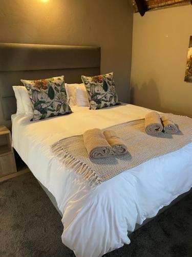 a bed with towels and pillows on it at Jock of the Bushveld in Barberton